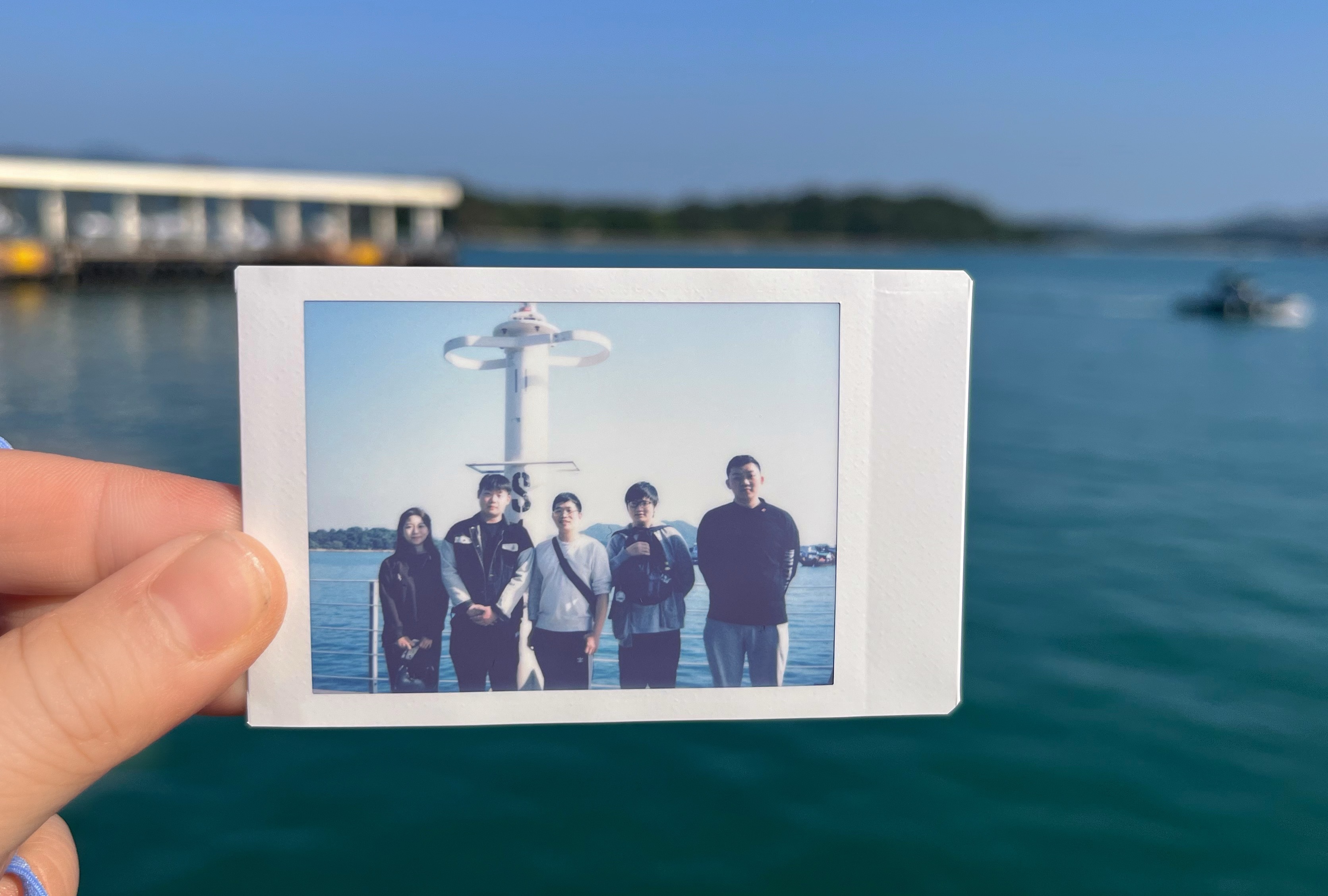 Group photo with polaroid at Moon Bay