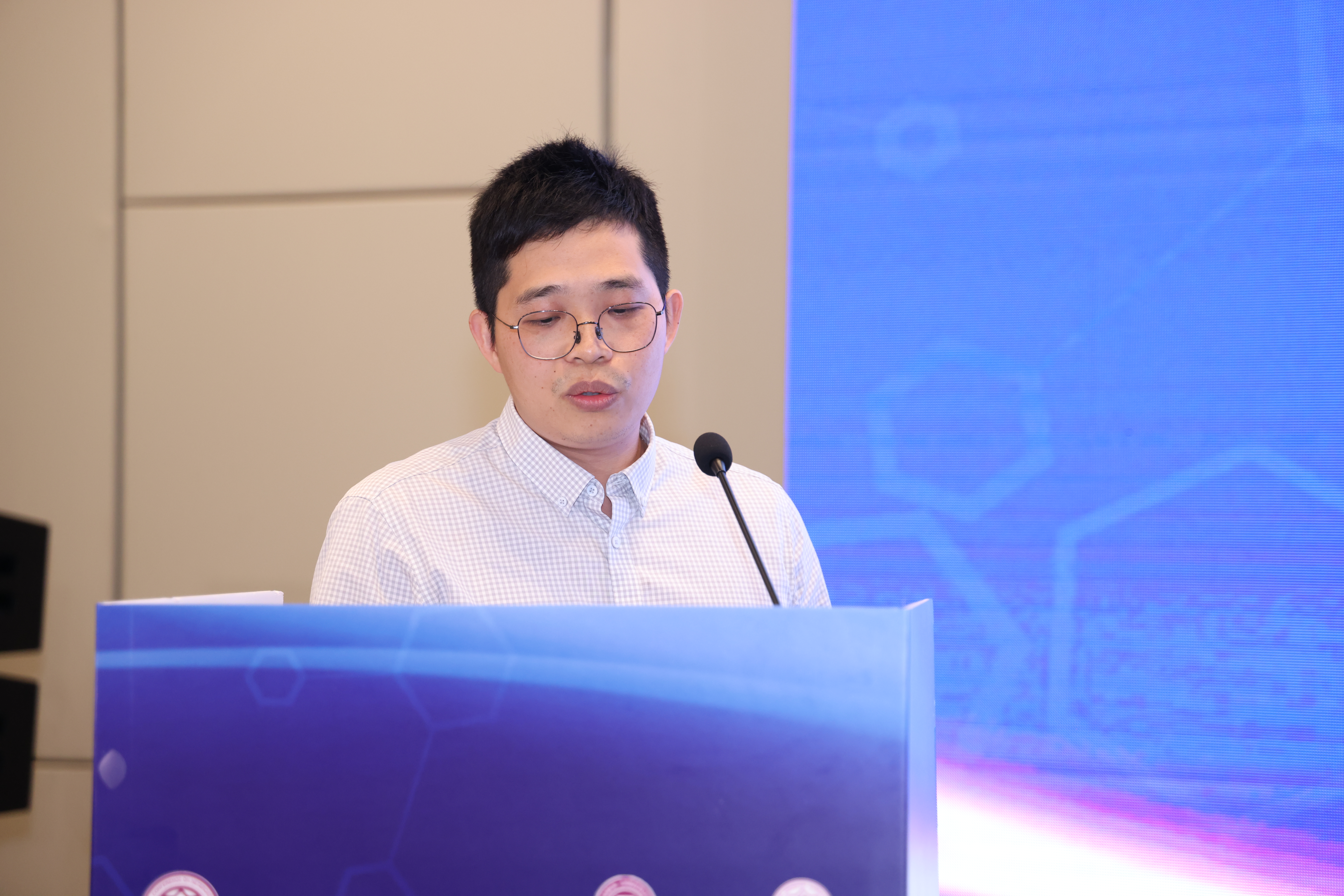 Prof. Lu speaking at the conference podium